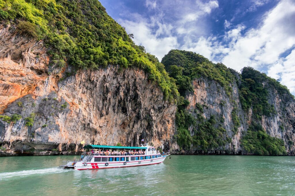 pexels-photo-358229-358229 A boat cruise offers breathtaking views of lush cliffs under a bright blue sky.